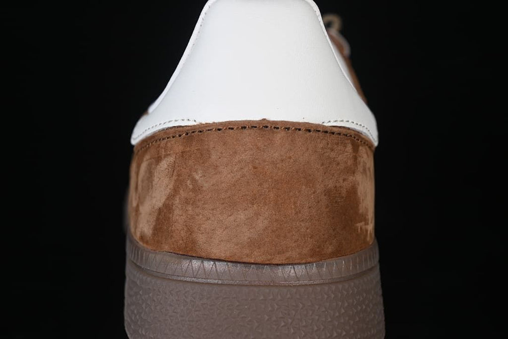 Rear view showing the brown heel panel, white heel tab, and gum-tone sole
