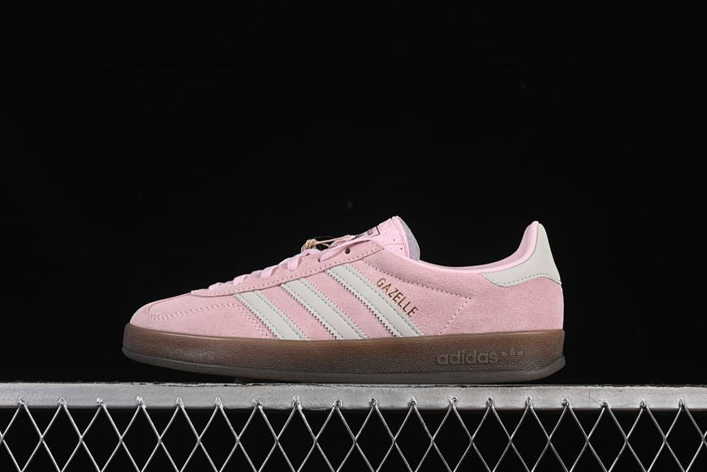 Side view of the pink Gazelle Indoor sneaker with pale stripes