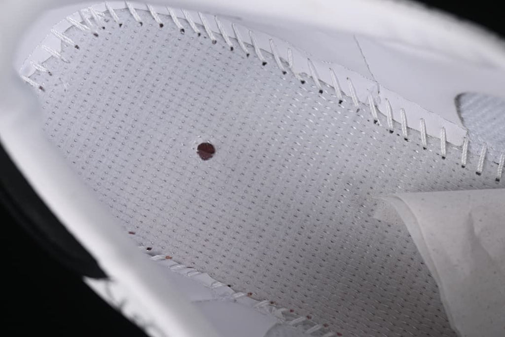Close-up view of the white perforated interior of the sneaker.