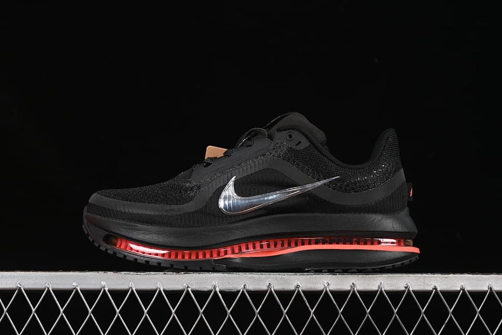 Side view of black Nike Air Zoom Pegasus Premium running shoe with silver Swoosh and coral sole accents