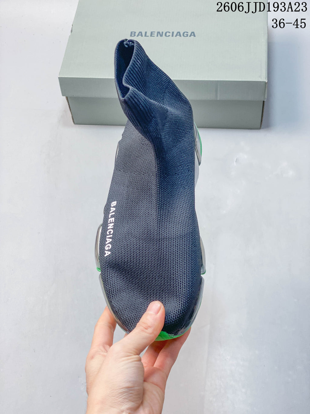 Top view of the navy sneaker showing its sock-like opening and side branding