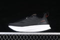Side view of a black adidas Ultraboost 5 shoe with a white midsole and red heel detail.