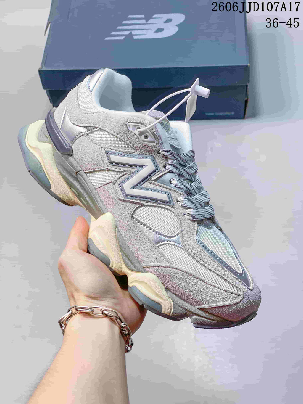 Side view of a grey and silver New Balance 9060 sneaker