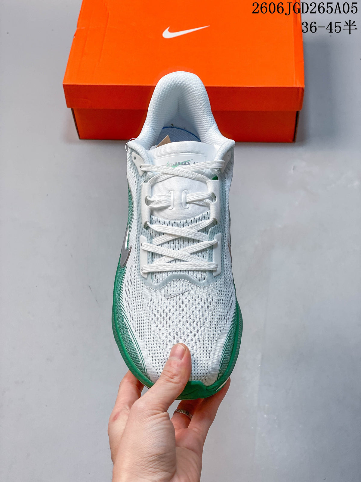 Top view of the white and green running shoe, with size range text visible in the image