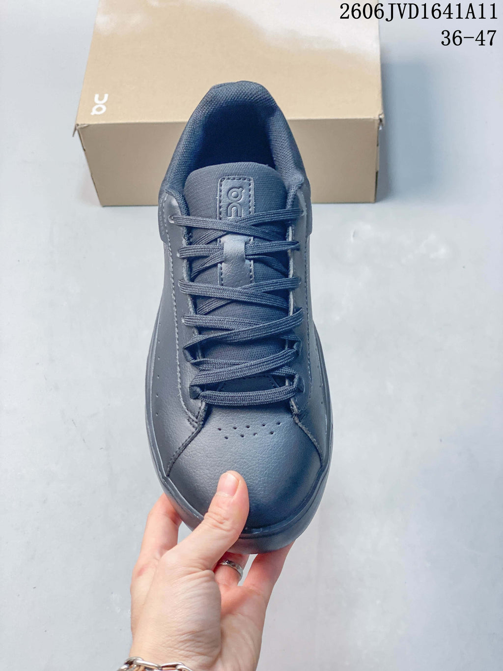 Top view of a slate-blue sneaker showing its laces and perforated toe