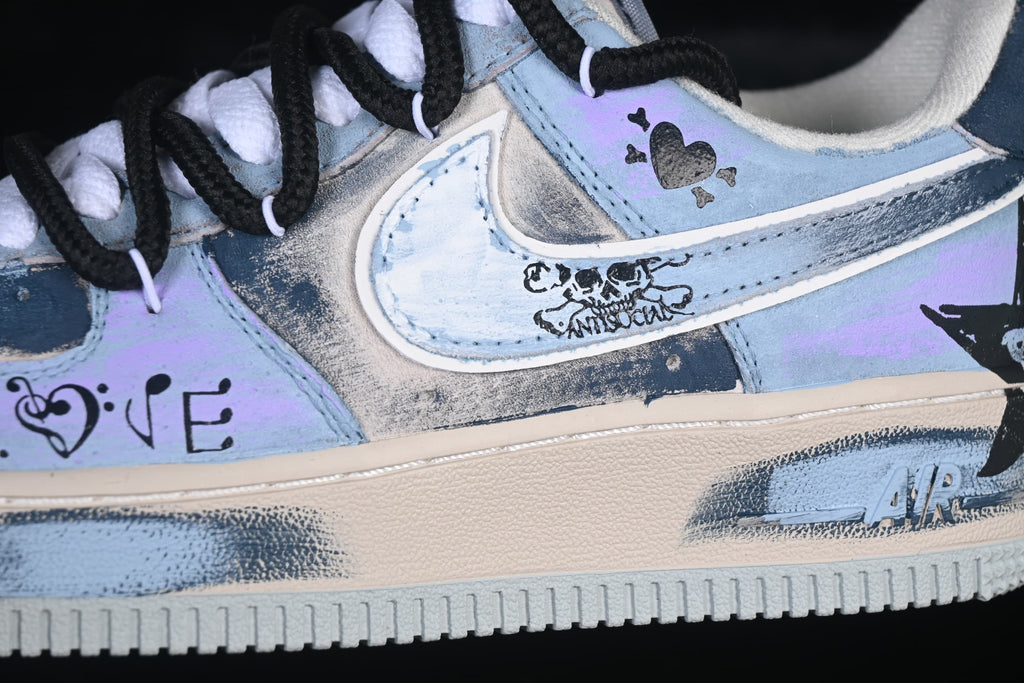 Close-up of the Swoosh and hand-drawn-style graphics on the sneaker side