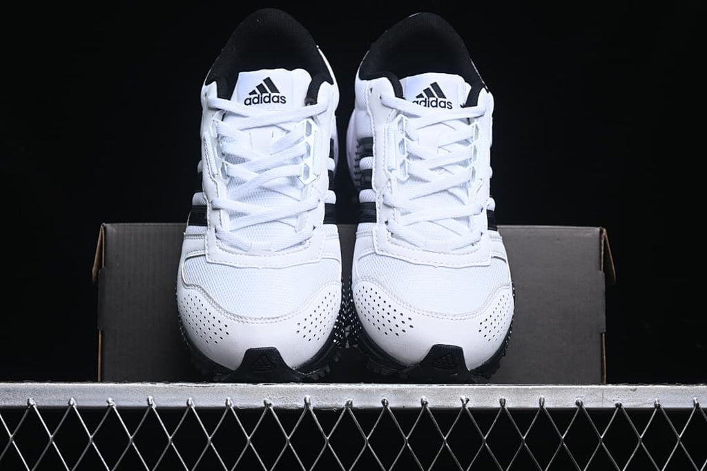 Front view of the pair of white and black sneakers