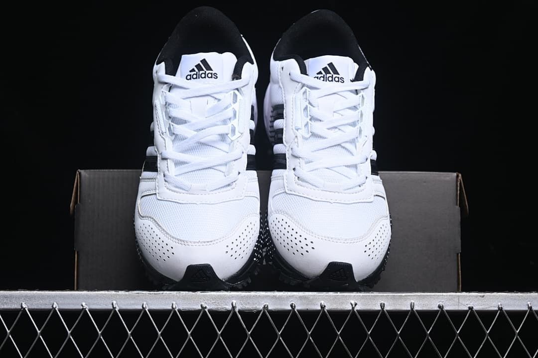 Front view of the pair of white and black sneakers