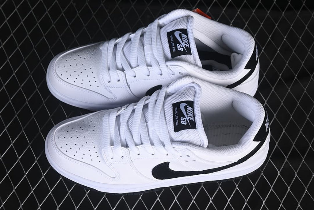 Pair of white and black low-top sneakers viewed from above