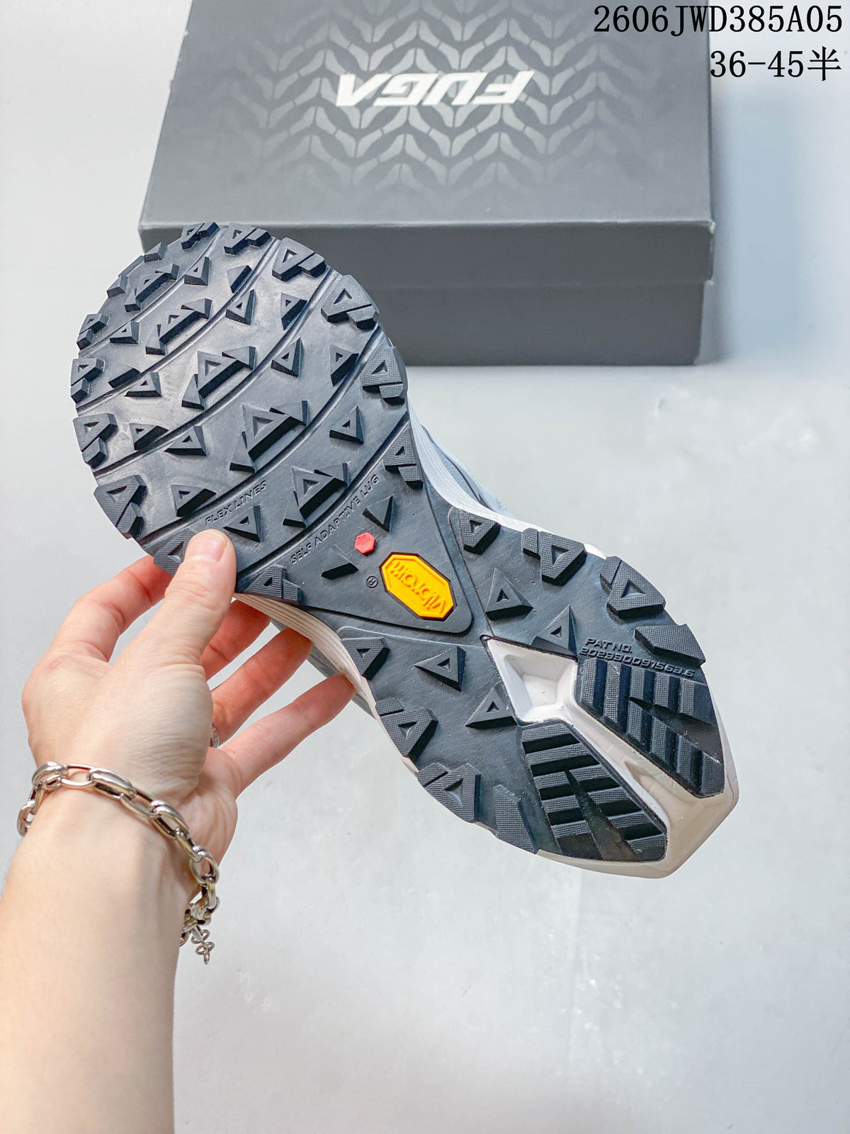 Close-up of the trail shoe outsole with deep tread and a Vibram logo