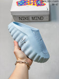 Light blue Nike Mind slide held in front of a Nike Mind box