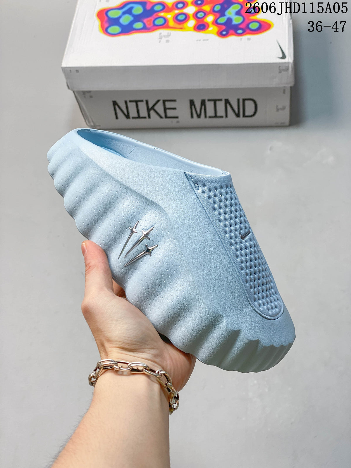 Light blue Nike Mind slide held in front of a Nike Mind box
