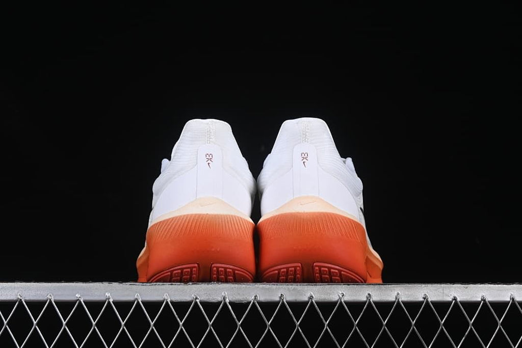 Rear view of the pair showing coral-orange heel soles