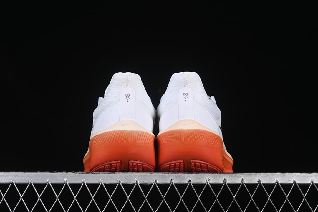 Rear view of the pair showing coral-orange heel soles