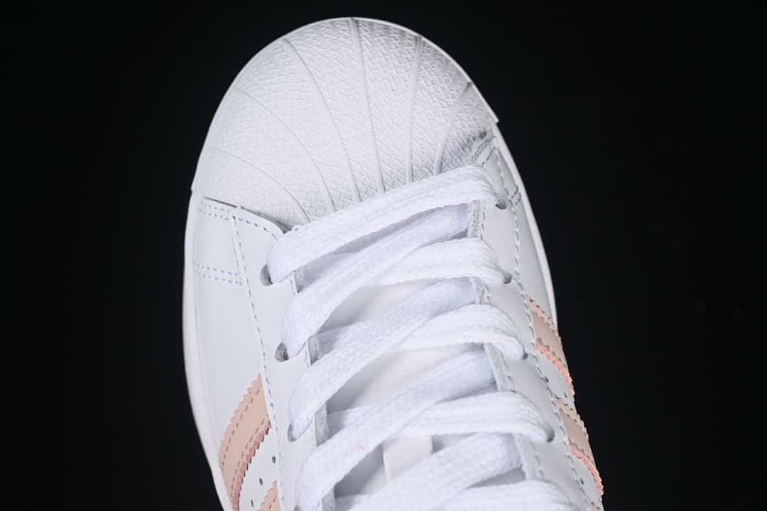 Top-down close-up of the shell toe and white lacing.