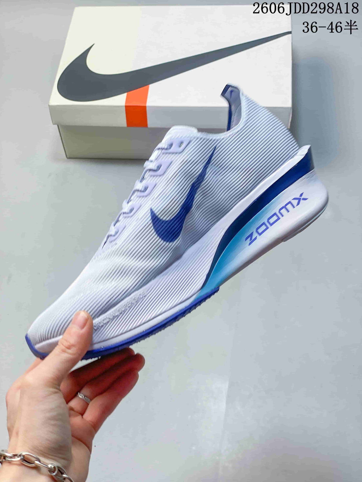 Side view of a light-colored running shoe with blue accents