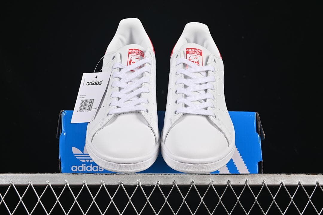 Front view of the pair displayed on a blue adidas box