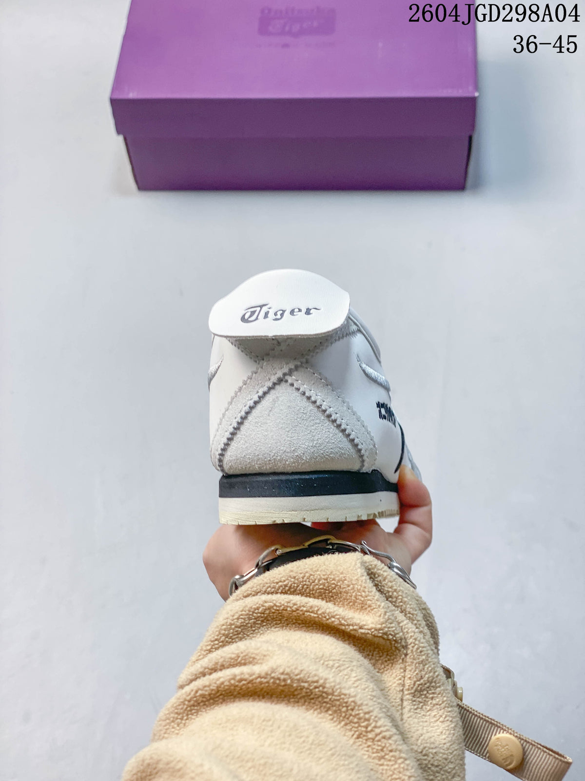 Rear view of a white sneaker showing gray heel detailing and a dark midsole accent.