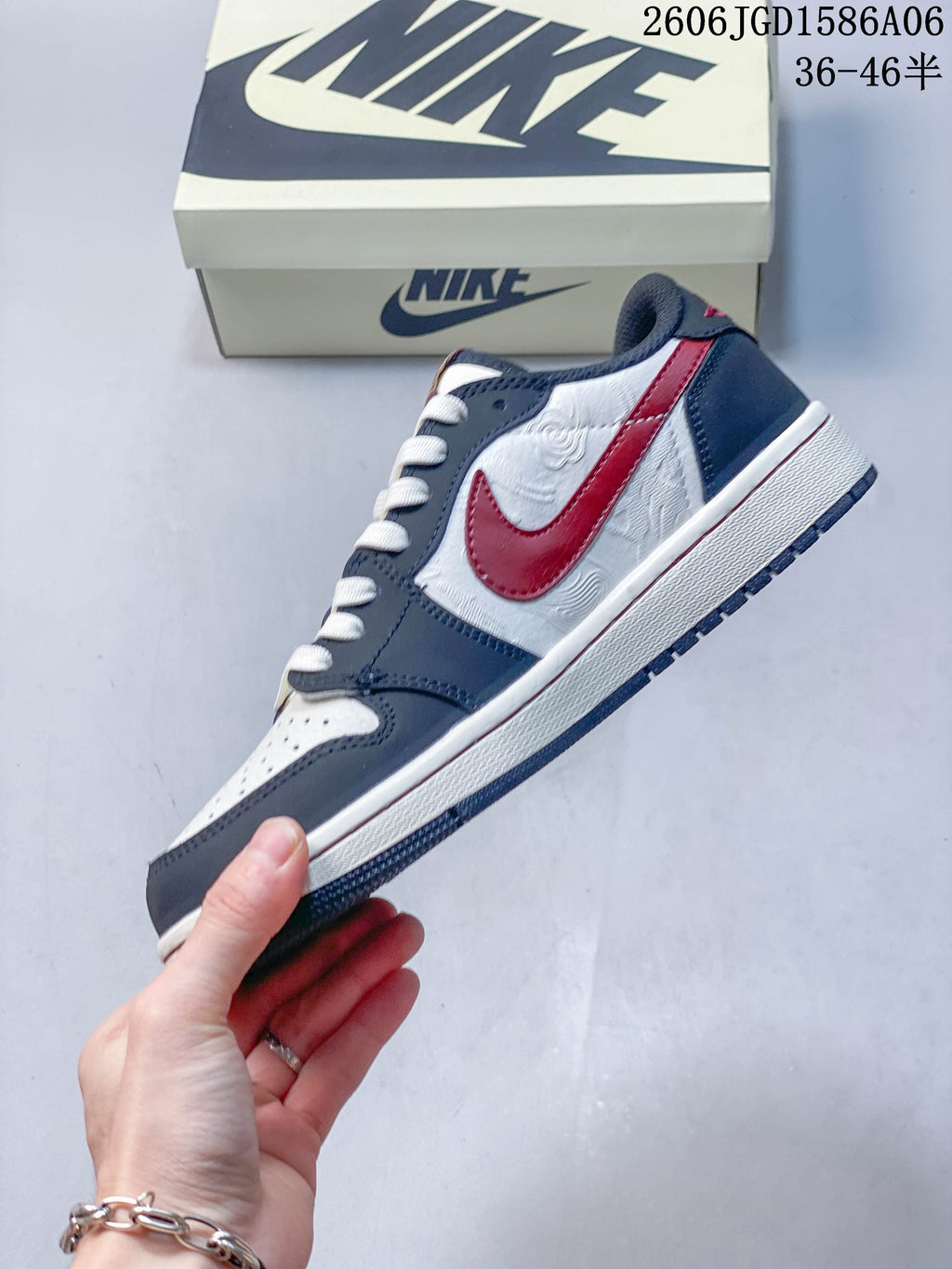 Side view of the low-top sneaker with a red side logo and patterned white panels