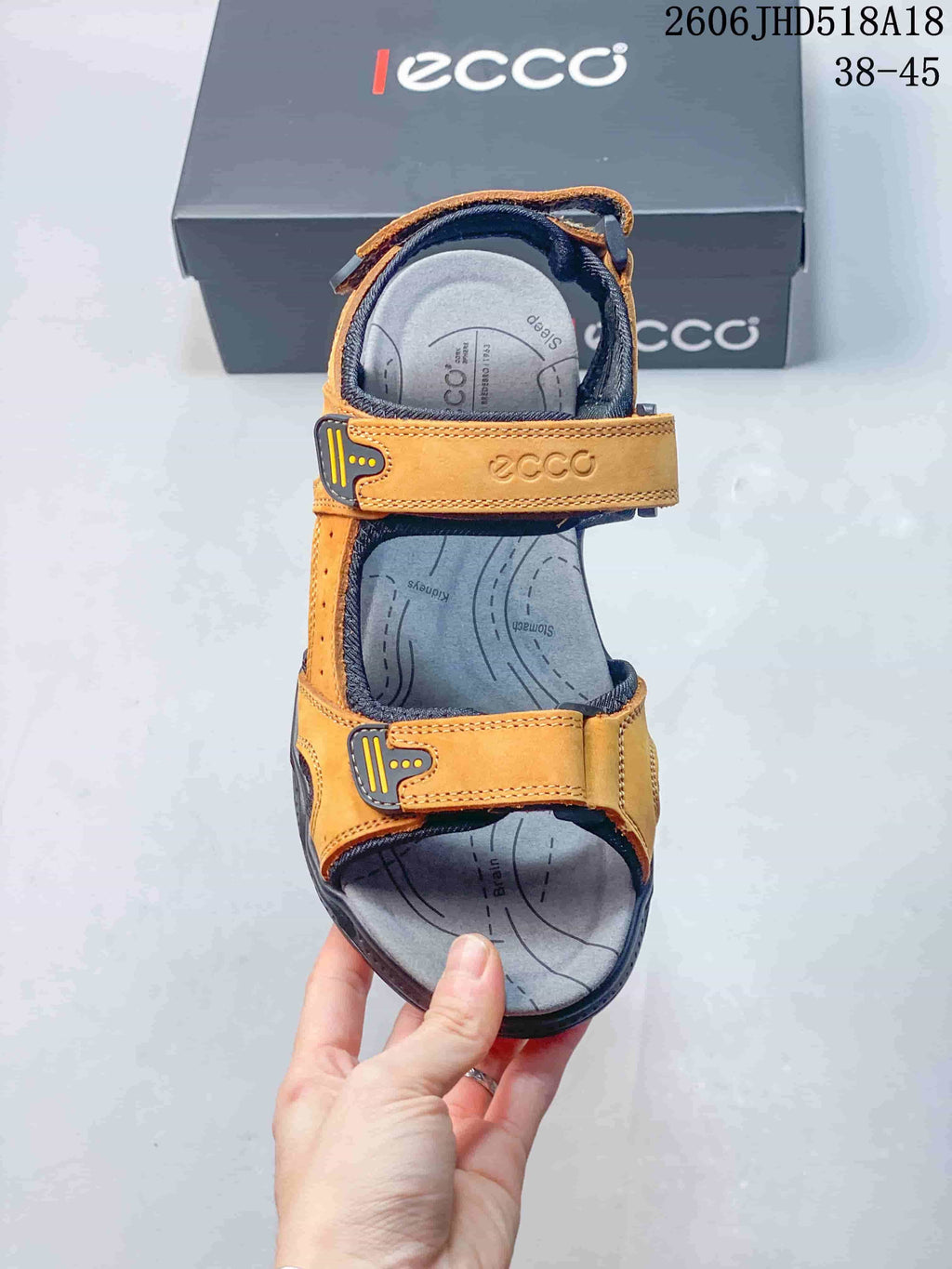 Top view of an orange and gray sandal showing its adjustable straps and footbed.