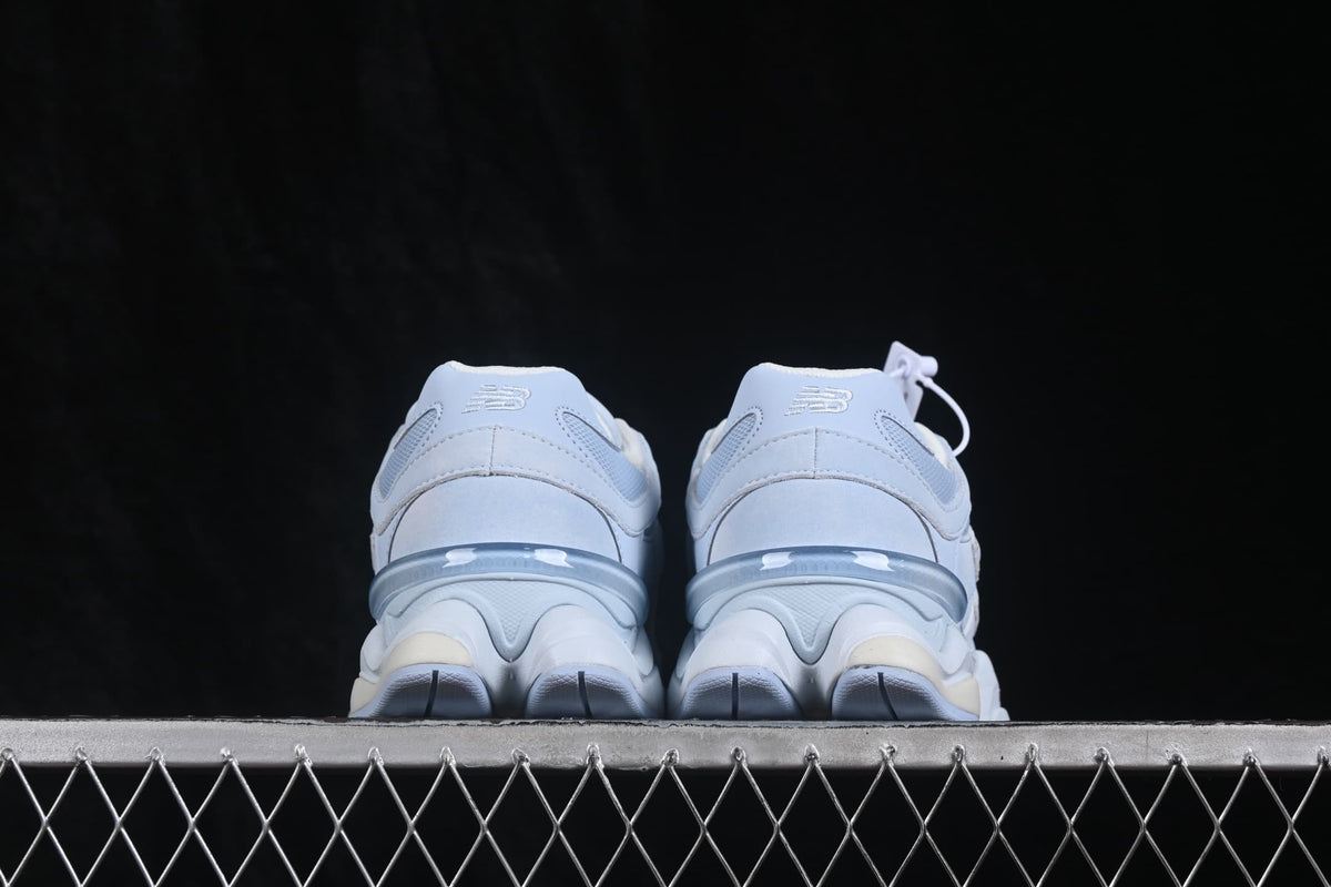 Rear view showing padded heel collars, New Balance branding, and the layered midsole.