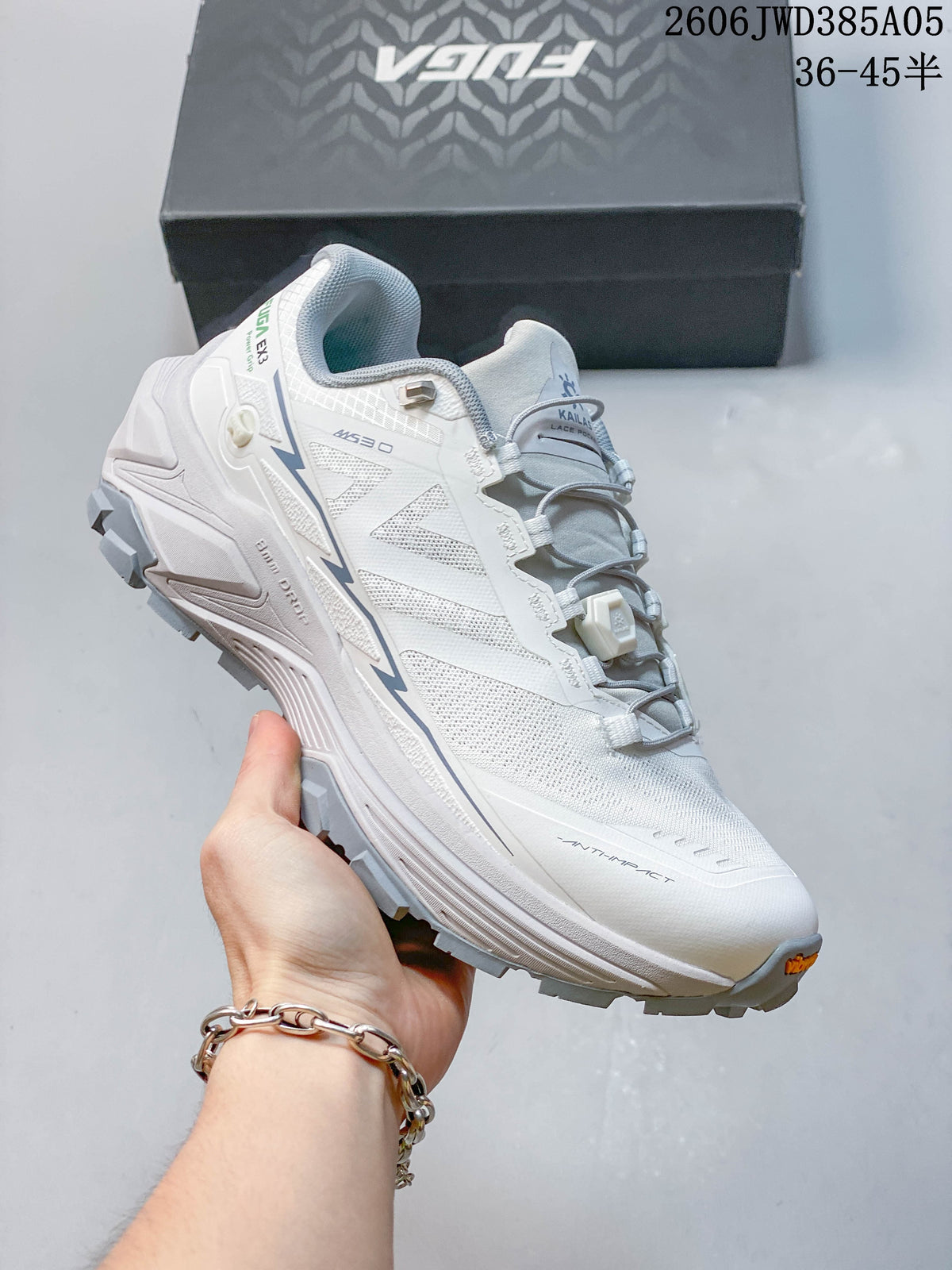Angled side view of the white Kailas Fuga Ex3 with gray accents and rugged outsole
