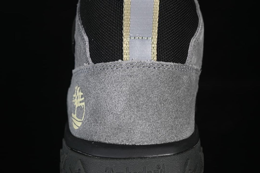 Rear view showing the grey heel panel, black collar, and pull loop.