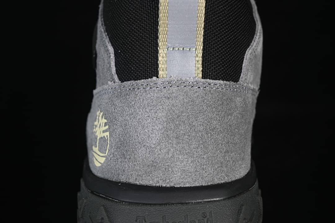 Rear view showing the grey heel panel, black collar, and pull loop.