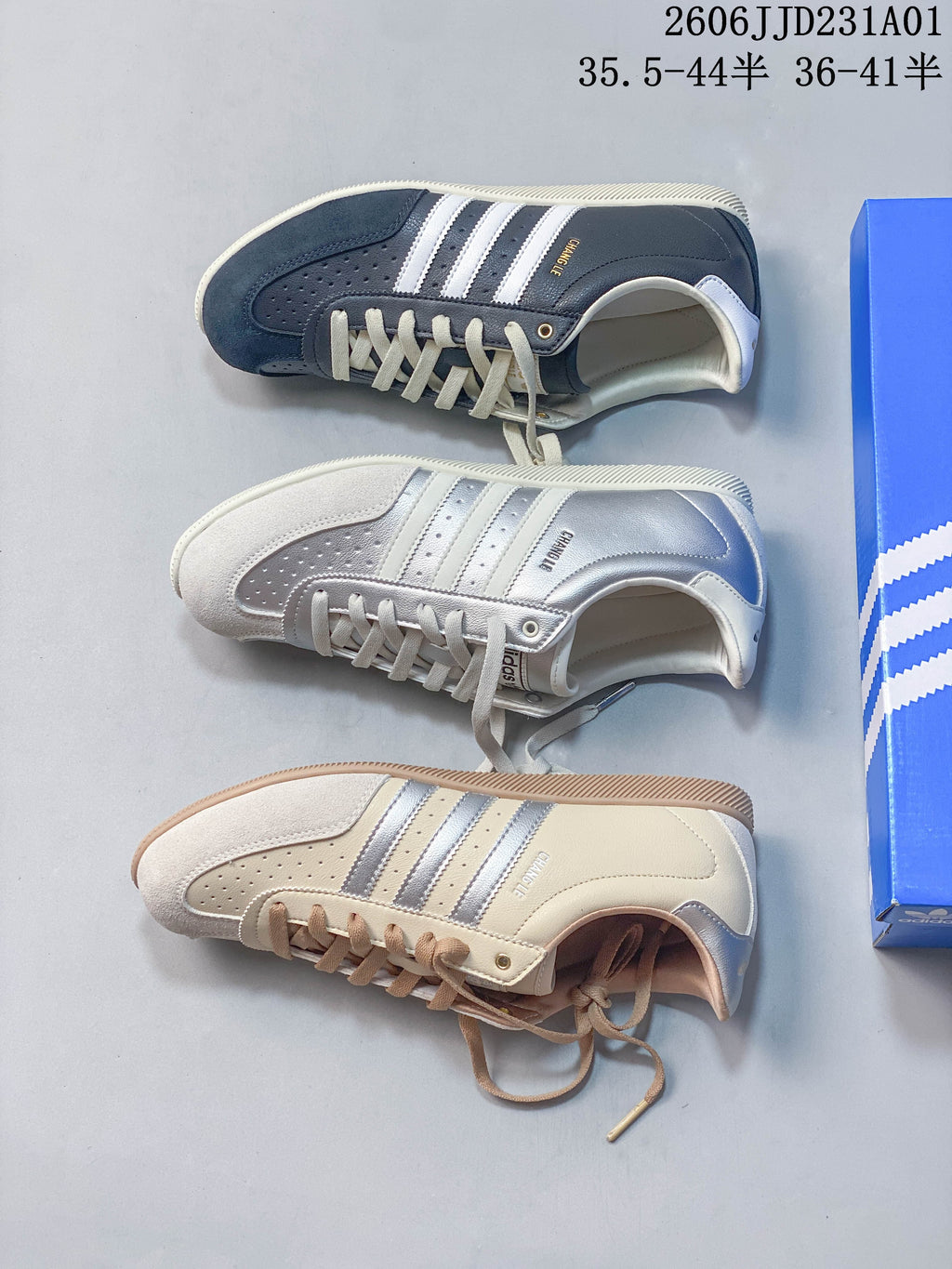 Overhead view of navy, silver, and cream Adidas Changle low-top sneakers.