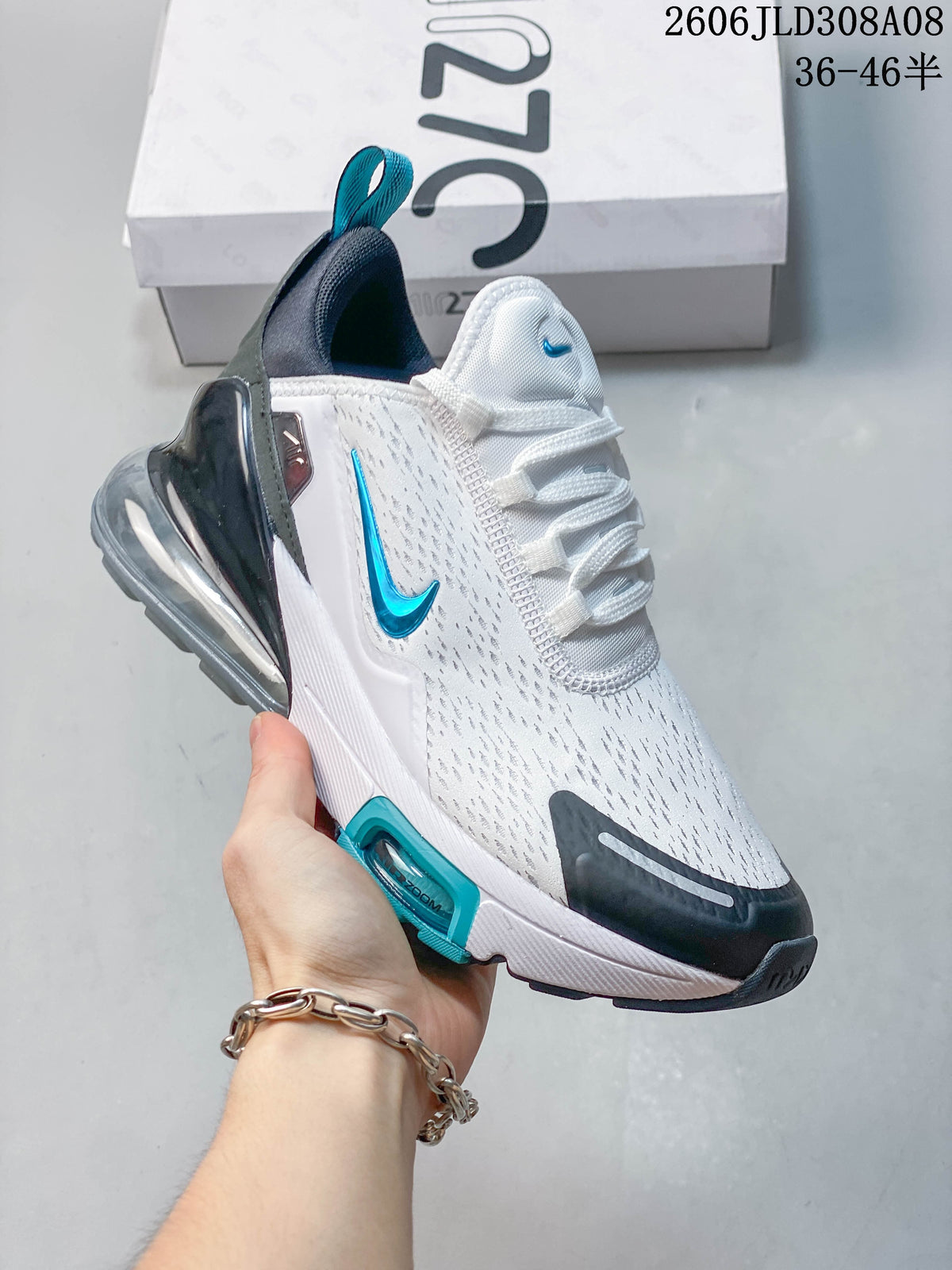 Angled side view of a white Nike Air Max 270 sneaker with turquoise Swoosh and transparent heel unit