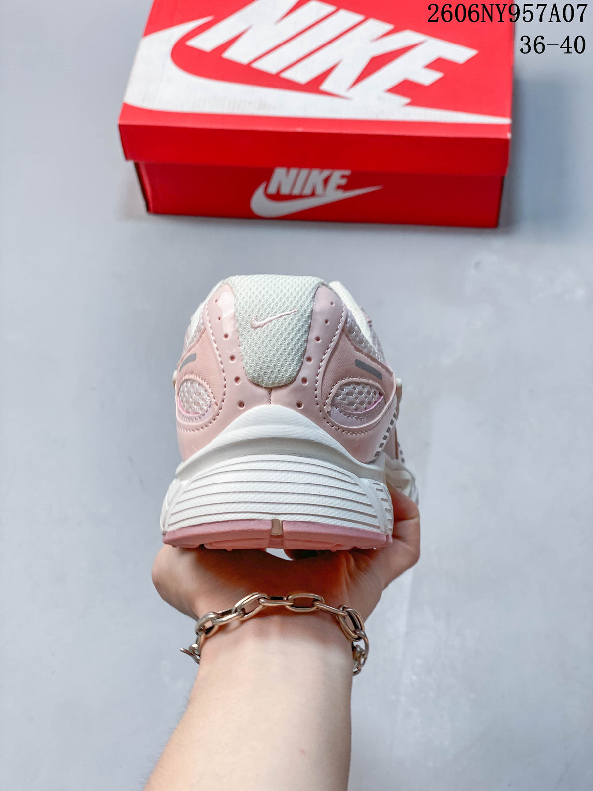 Rear view of a pale pink and white Nike V5 RNR sneaker