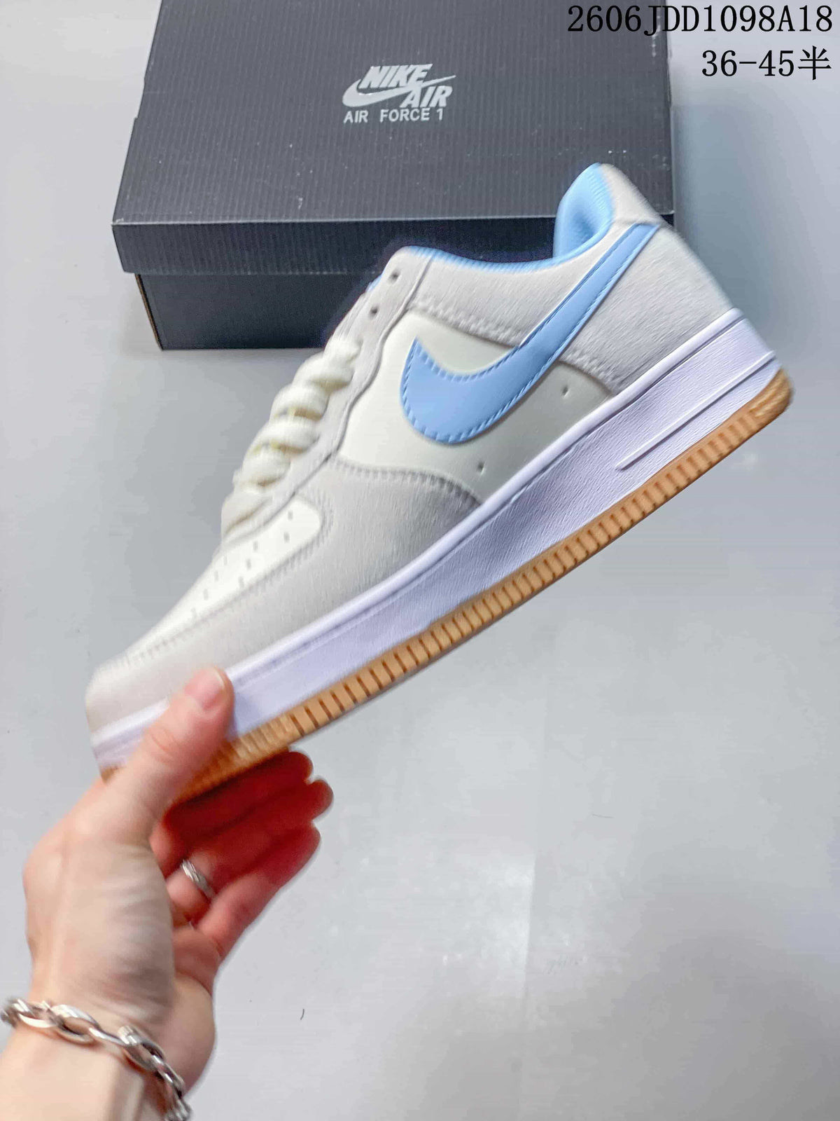 Side view of an off-white Nike Air Force 1 with light blue accents