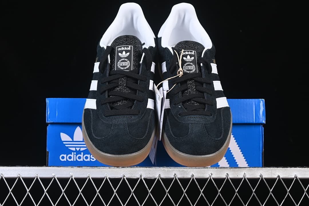 Front view of the pair of black and white low-top sneakers.