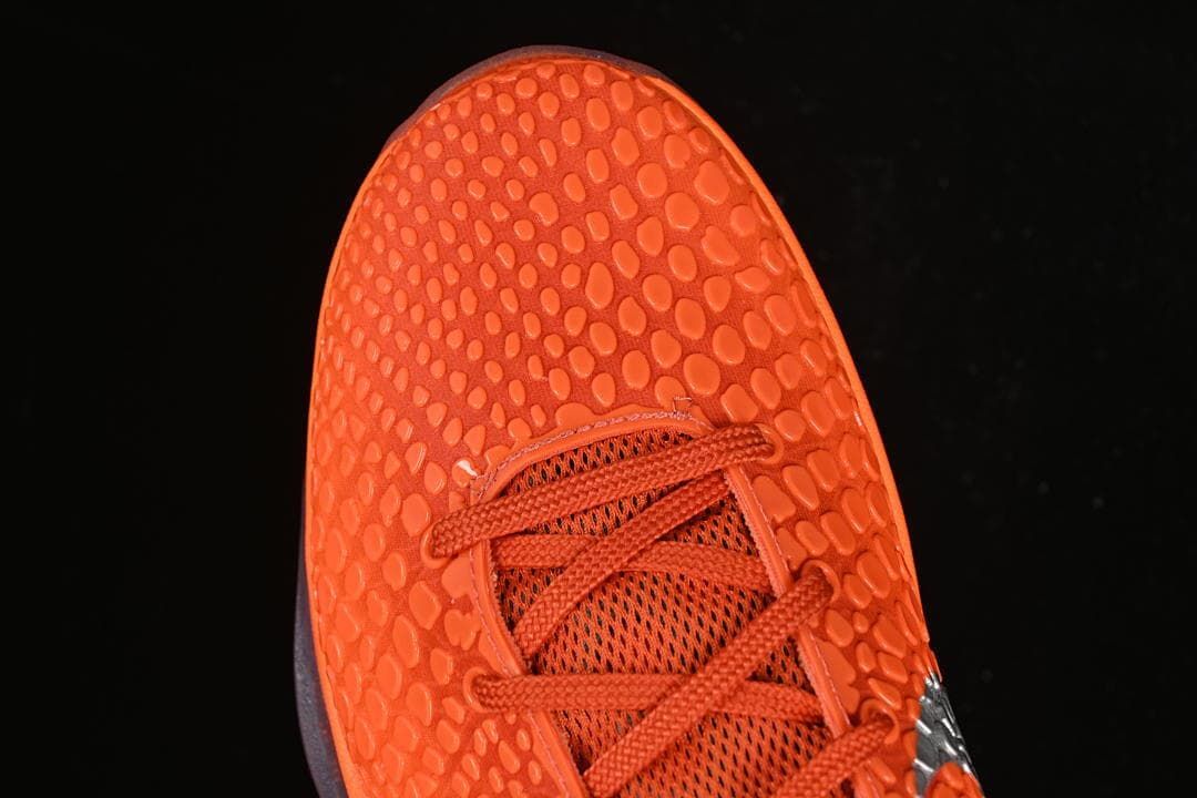Top-down view of orange textured toe and lacing