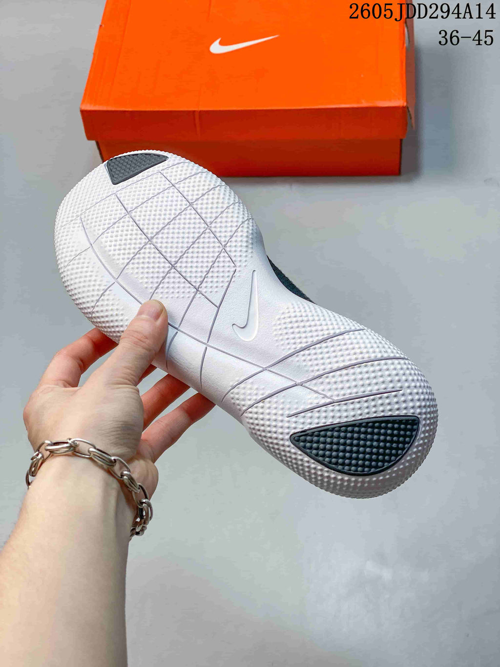 Underside of the white Nike Free sole showing grooves and textured sections
