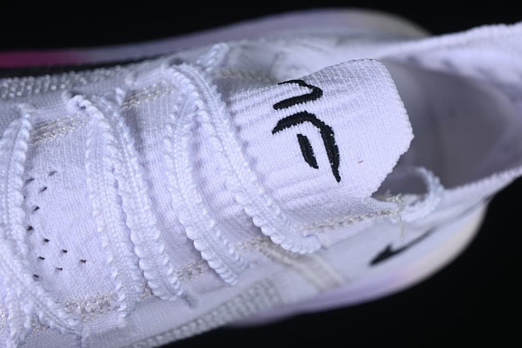 Close-up of the tongue and lacing on the white running shoe