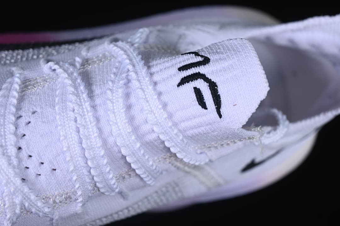 Close-up of the tongue and lacing on the white running shoe