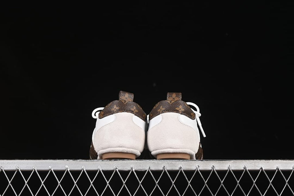Rear view of both shoes showing beige heel overlays and brown patterned heel panels.