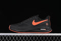 Side view of a black Nike Winflo 7 shoe with a coral-orange Swoosh and outsole accents.