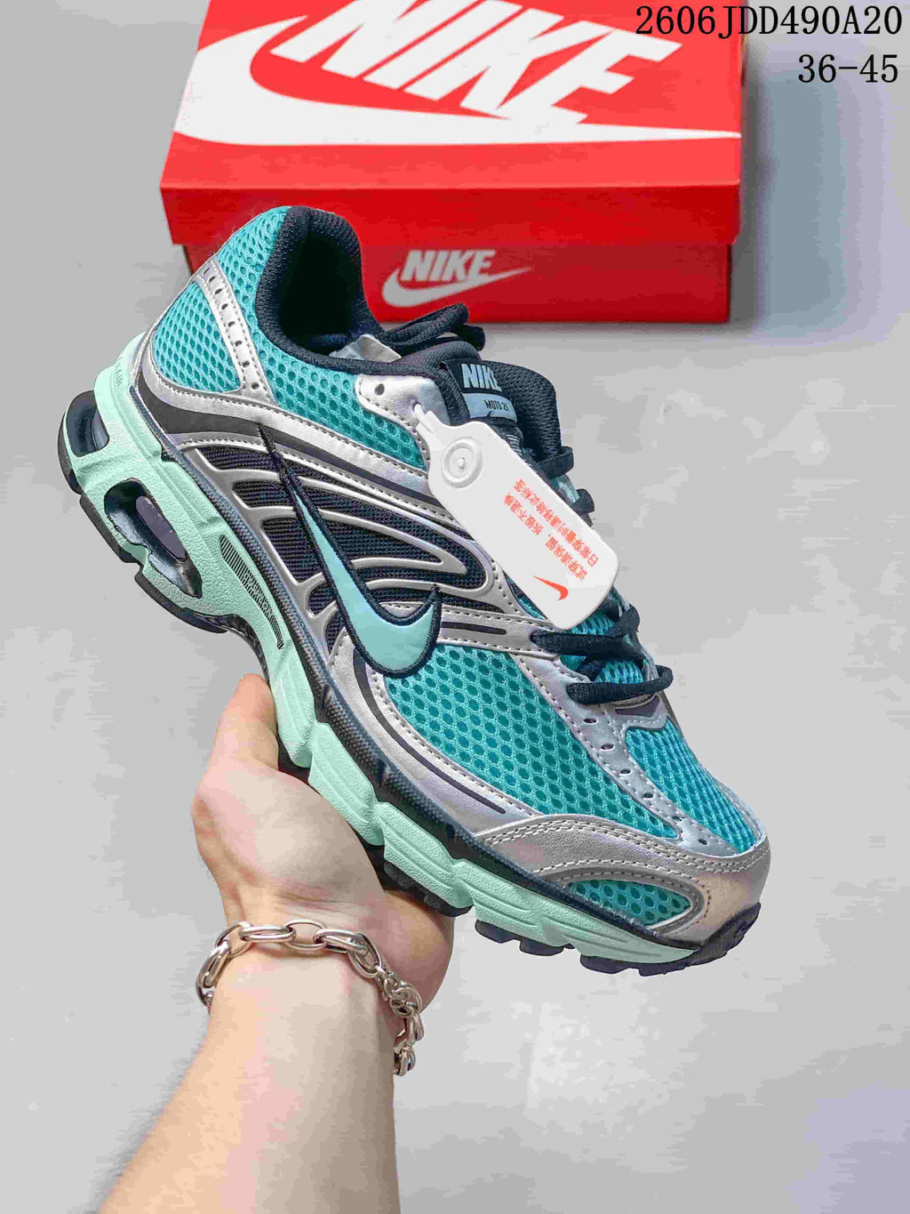 Teal and silver Nike Air Max Moto 2K sneaker with dark accents