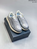 Pair of silver Onitsuka Tiger Delecity low-top sneakers on a shoebox