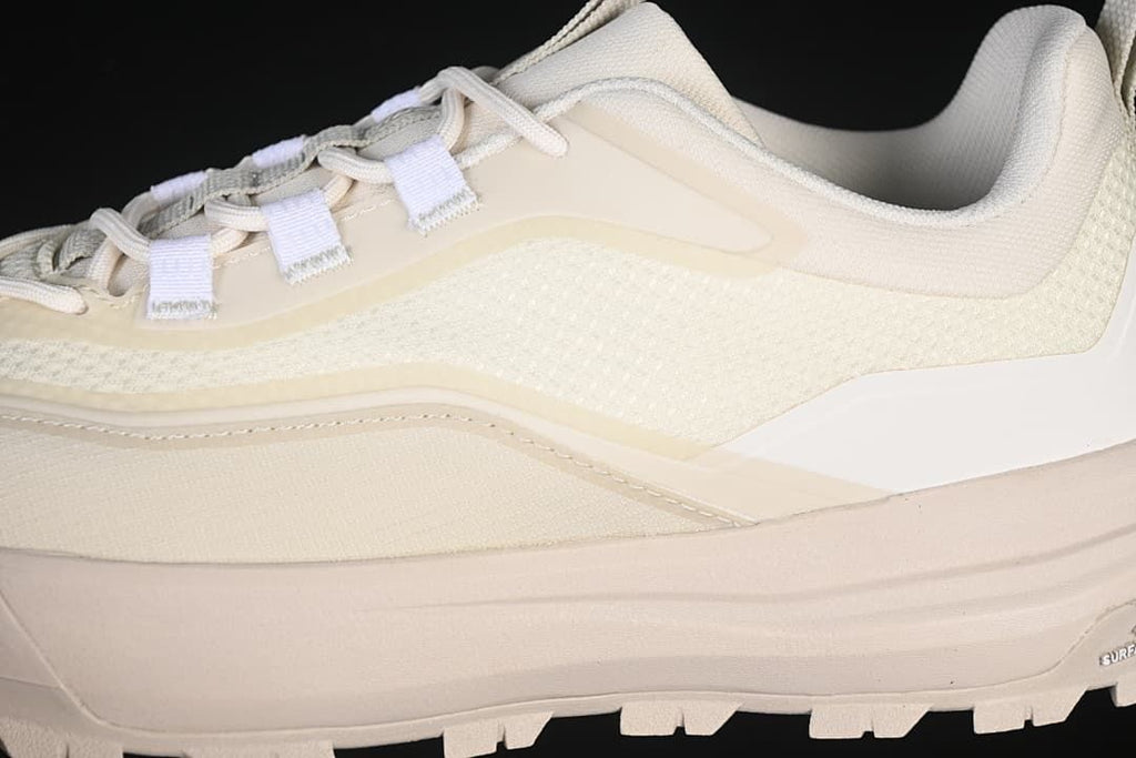 Close-up of the shoe's lace area, upper panels, and thick sole