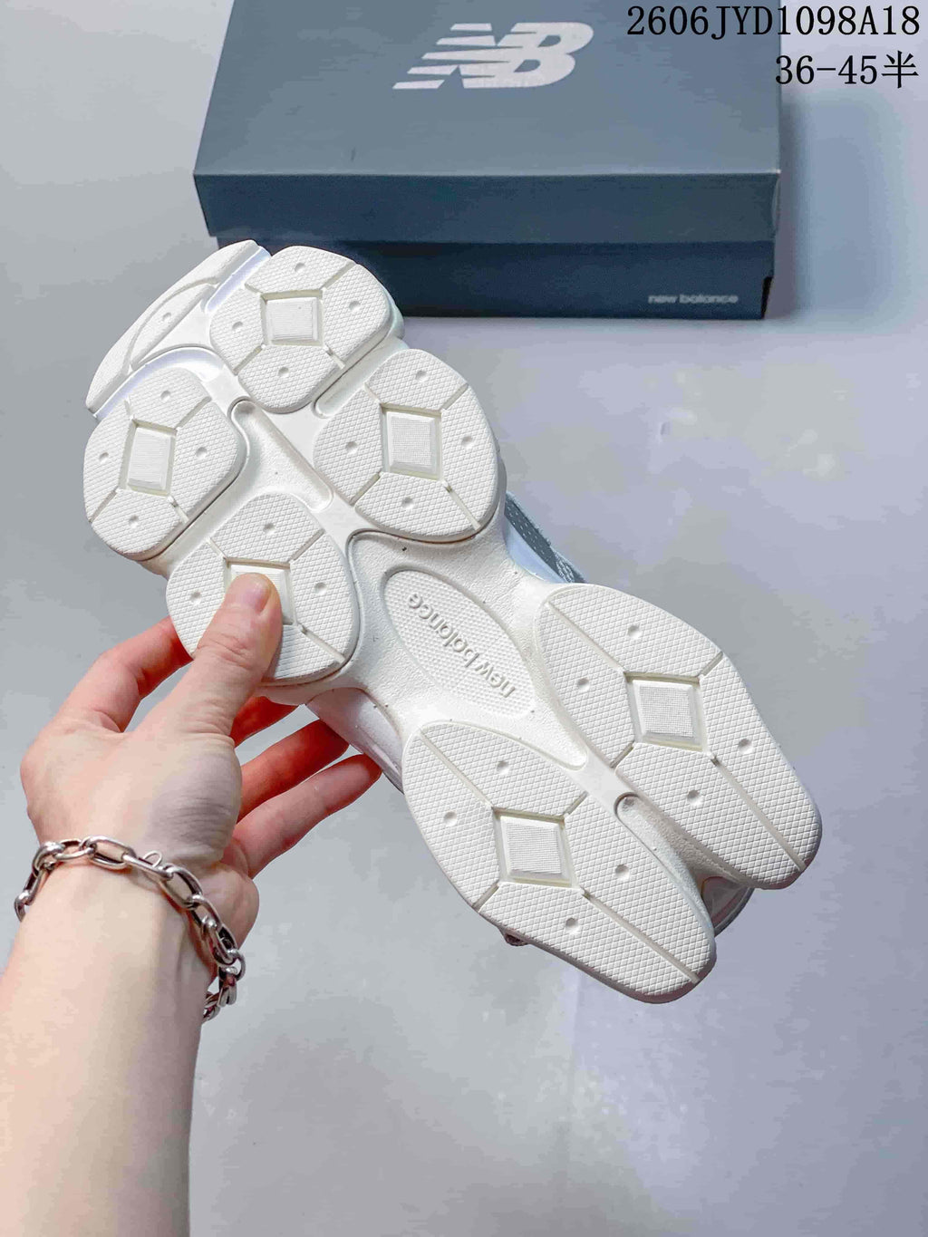 Underside of the sneaker showing a white outsole with segmented tread.