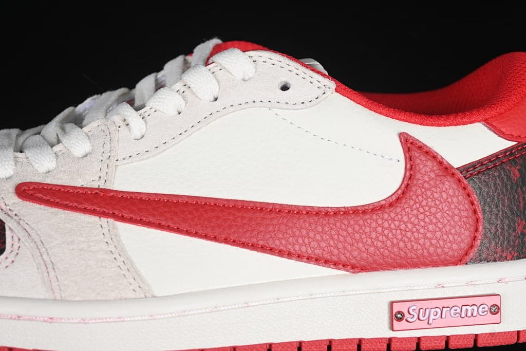 Close-up of the red Swoosh overlay, white side panel, and side plaque.