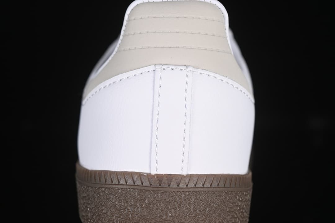 Rear view showing the light neutral heel tab, white heel panel, and brown outsole