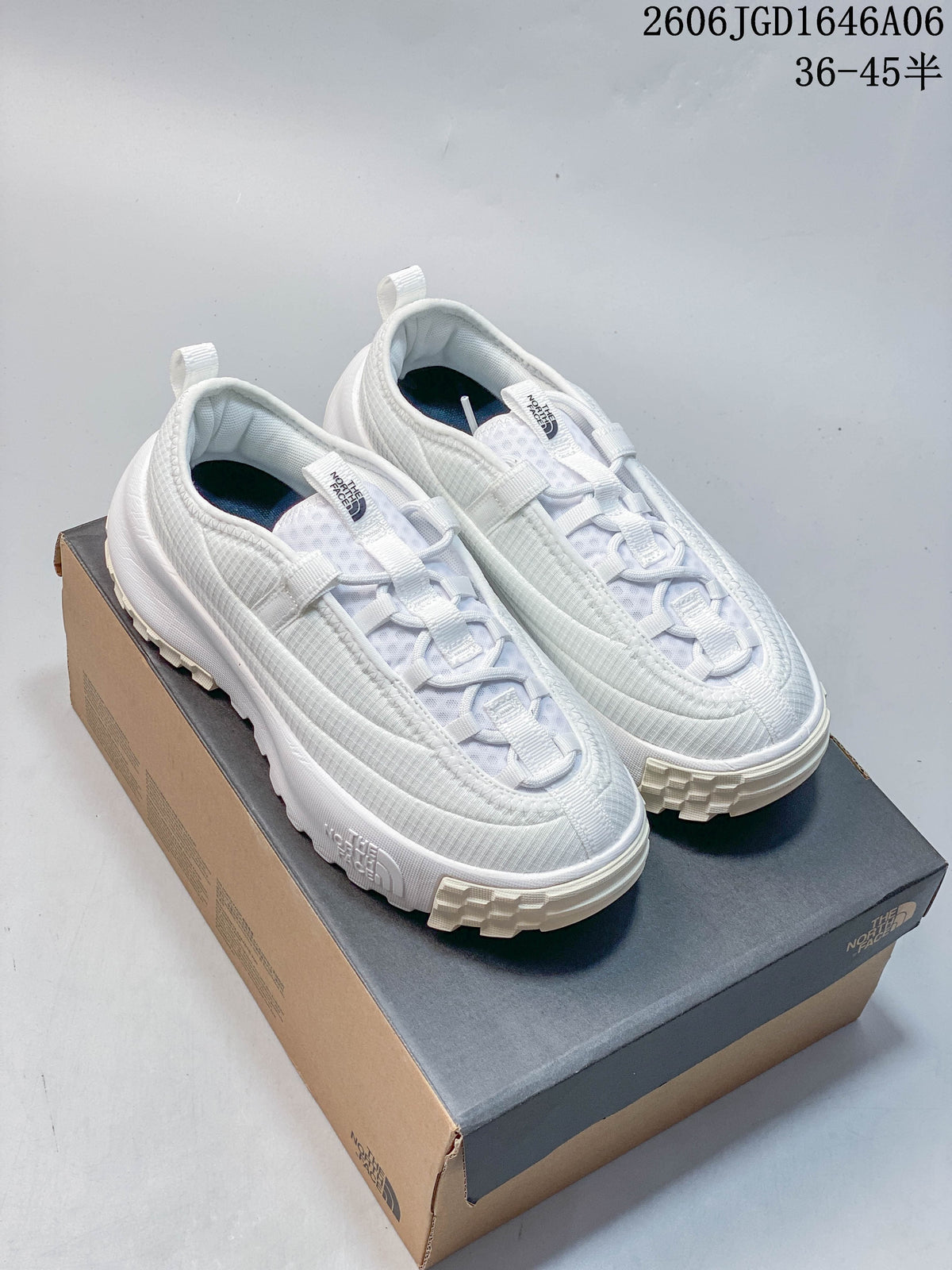 Pair of white The North Face ThermoBall Traction Mule V shoes on a shoebox.