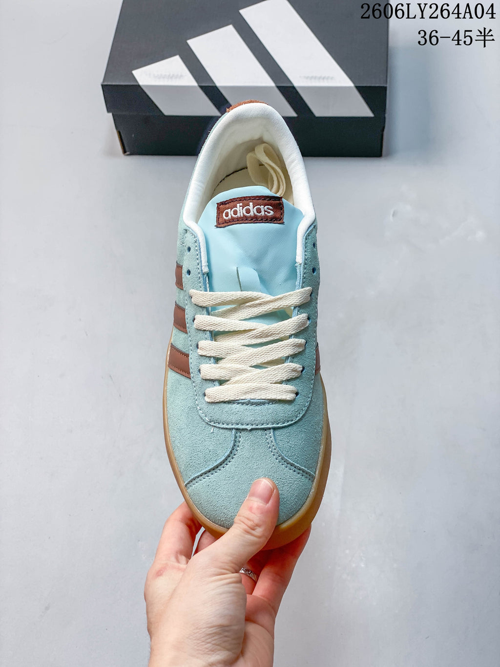 Top view of the sneaker showing cream laces, blue upper, and brown tongue label