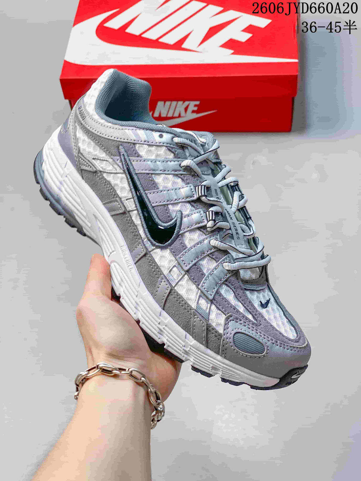 Angled side view of a silver and grey Nike P-6000 sneaker.