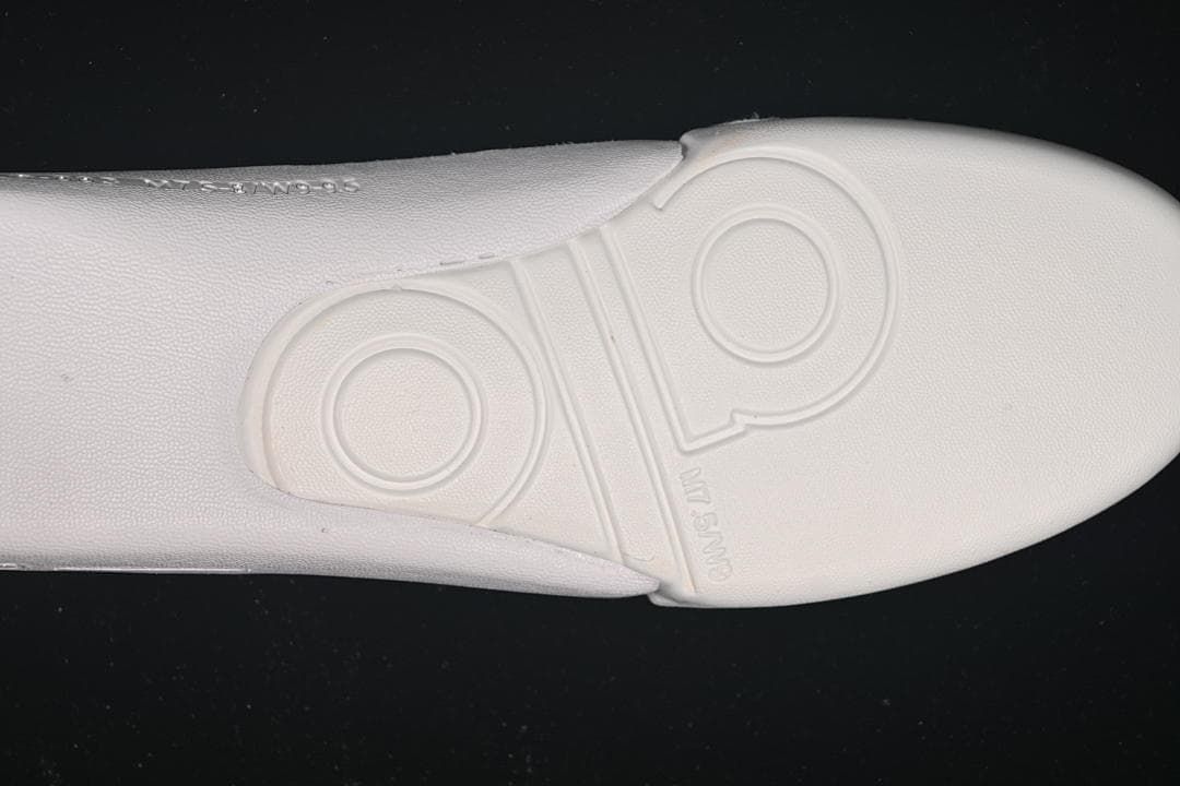 Close-up of the sneaker outsole with molded circular and logo details