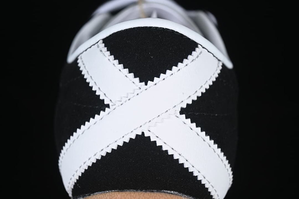 Rear view of the sneaker showing crossed white heel stripes